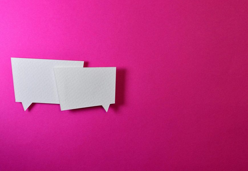 White speech bubbles on a vibrant pink background for communication or design concepts.